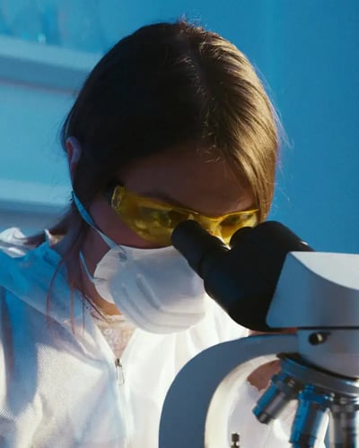 Biotech Woman Using Microscope